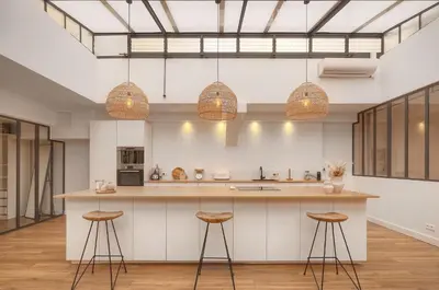 a kitchen with a large island with stools at Le Trendee - Loft atypique in Cannes