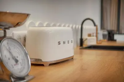 a toaster sitting on a counter next to a scale at Le Trendee - Loft atypique in Cannes