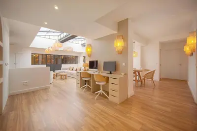 a living room with a couch and a table at Le Trendee - Loft atypique in Cannes