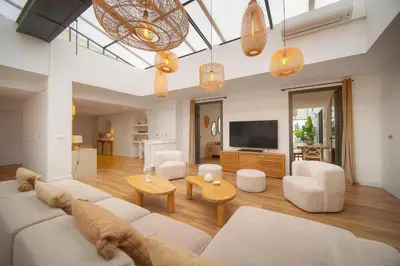 a living room with a white couch and a tv at Le Trendee - Loft atypique in Cannes
