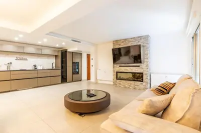 a living room with a couch and a fireplace at Appartement en bord de mer avec piscine - Cannes in Cannes