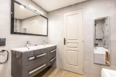 a bathroom with a sink and a mirror at Appartement en bord de mer avec piscine - Cannes in Cannes