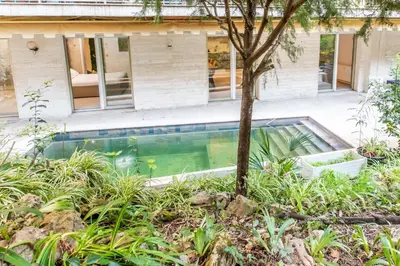 a swimming pool in front of a house at Appartement en bord de mer avec piscine - Cannes in Cannes
