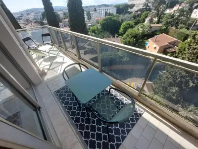 a bench sitting on a balcony with a table at Studio Le Floriana-2 by Interhome in Cannes
