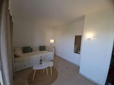 a living room with a couch and a table at Studio Le Floriana-2 by Interhome in Cannes