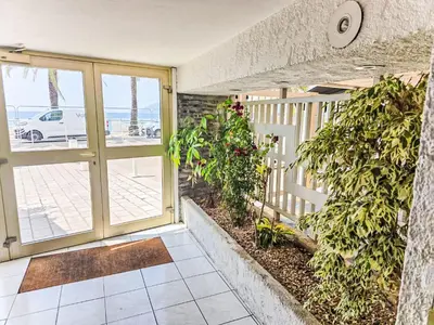 a door to a balcony with a view of the ocean at Apartment Le Panoramer by Interhome in Cannes