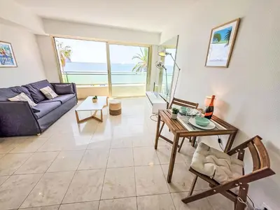 a living room with a couch and a table at Apartment Le Panoramer by Interhome in Cannes