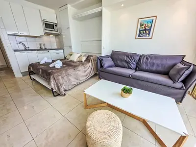 a living room with a couch and a table at Apartment Le Panoramer by Interhome in Cannes