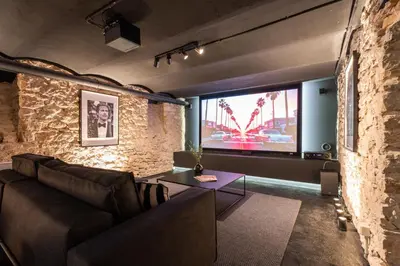 a living room with a couch and a large window at Appartement Montrose - Welkeys in Cannes