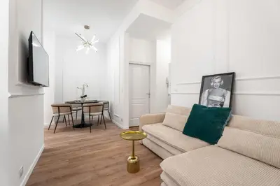a living room with a couch and a table at Appartement Montrose - Welkeys in Cannes