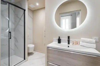 a bathroom with a sink and a mirror at Appartement Prado - Welkeys in Cannes