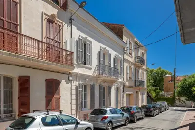 a row of cars parked on a street next to buildings at Studio Bella - Welkeys in Cannes