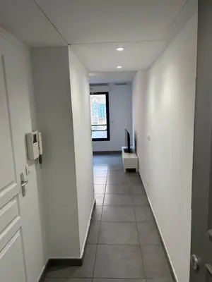 an empty hallway with a door and a room at studio confortable in Cannes
