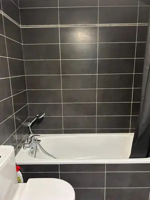 a bathroom with a white tub and a toilet at studio confortable in Cannes