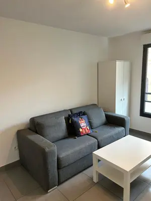 a living room with a couch and a table at studio confortable in Cannes