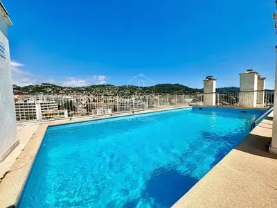 a swimming pool on the balcony of a building at Le Beauséjour, studio with pool, parking, air conditioning in Le Cannet