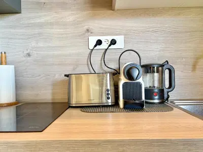 a kitchen counter with a coffee maker and a toaster at Le Beauséjour, studio with pool, parking, air conditioning in Le Cannet