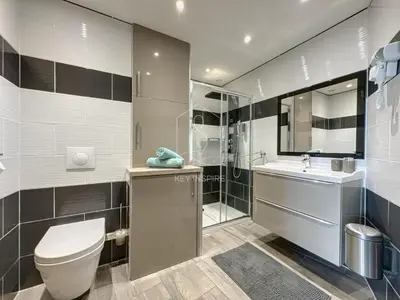 a bathroom with a toilet and a sink and a shower at Le Beauséjour, studio with pool, parking, air conditioning in Le Cannet