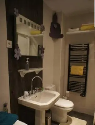 a bathroom with a sink and a toilet and a mirror at CANNES POINTE CROISETTE Garden & Beach in Cannes