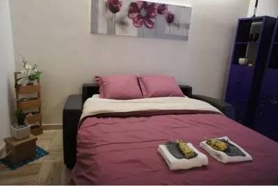a bedroom with a bed with two plates of food on it at CANNES POINTE CROISETTE Garden & Beach in Cannes