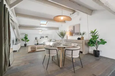 a dining room with a table and chairs at Appartement Reyer - Welkeys in Cannes