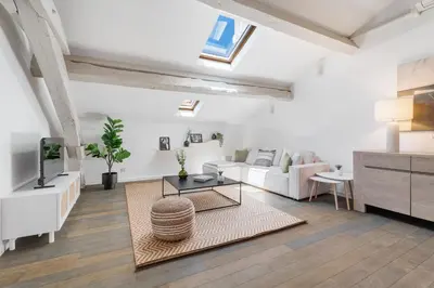 a living room with a couch and a table at Appartement Reyer - Welkeys in Cannes