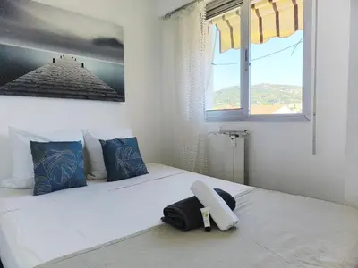 a bedroom with a bed with a phone on it at Quadruple bedroom apartment in Cannes