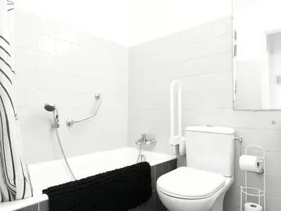 a white bathroom with a toilet and a bath tub at Quadruple bedroom apartment in Cannes