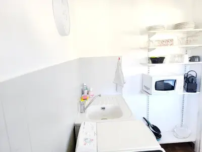a white kitchen with a sink and a microwave at Quadruple bedroom apartment in Cannes
