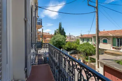 a balcony with a view of a city at Appartement Caire - Welkeys in Cannes