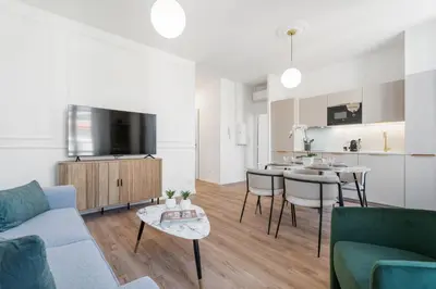 a living room with a couch and a table at Appartement Caire - Welkeys in Cannes