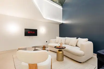 a living room with a couch and a table at Cèdre Bleu - Chic Peaceful Haven near Croisette in Cannes