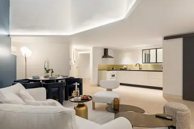 a living room with a white couch and a table at Cèdre Bleu - Chic Peaceful Haven near Croisette in Cannes