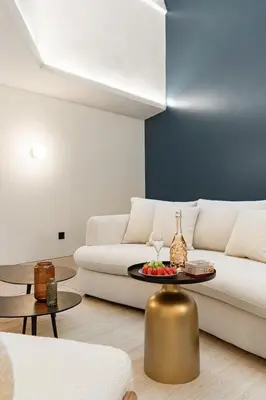 a living room with a white couch and a table at Cèdre Bleu - Chic Peaceful Haven near Croisette in Cannes