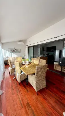 a living room with a table and a dining room at Cannes Centre Le bourbon 1min mer et Croisette in Cannes
