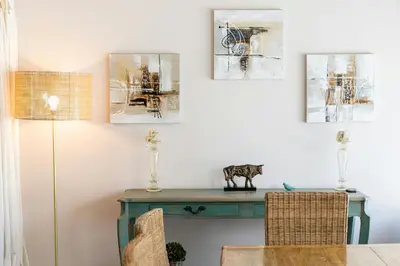 a dining room with a blue table and pictures on the wall at Cannes Centre Le bourbon 1min mer et Croisette in Cannes