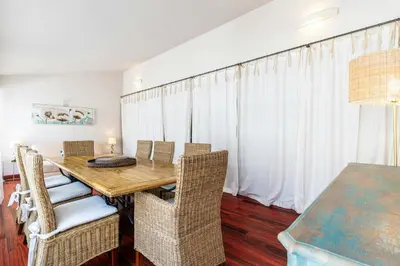 a dining room with a wooden table and chairs at Cannes Centre Le bourbon 1min mer et Croisette in Cannes