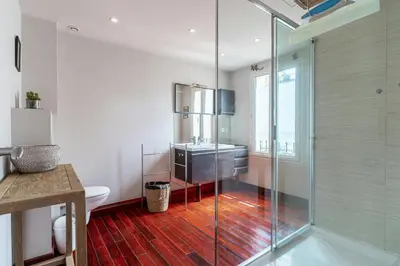 a bathroom with a glass shower and a sink at Cannes Centre Le bourbon 1min mer et Croisette in Cannes
