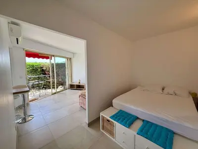 a small bedroom with a bed and a balcony at B084-Confort et serenite piscine et stationnement in Cannes