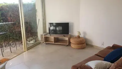 a living room with a flat screen tv on a stand at B084-Confort et serenite piscine et stationnement in Cannes