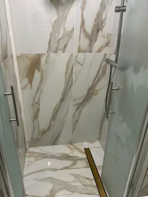 a bathroom with a shower with marble tiles at Cannes Croisette in Cannes