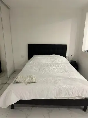 a white bed with a black headboard in a bedroom at Cannes Croisette in Cannes
