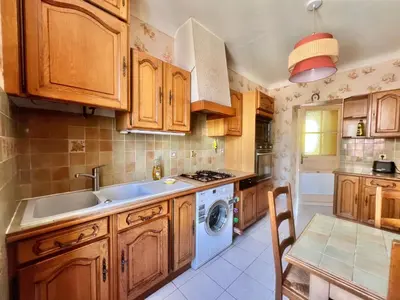 a kitchen with wooden cabinets and a sink and a dishwasher at Belle-epoque apartment ,3bedrooms with sea view in Cannes