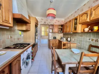 a kitchen with a table and a stove top oven at Belle-epoque apartment ,3bedrooms with sea view in Cannes