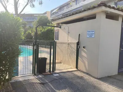 a gate in front of a building with a pool at Studio neuf parking piscine à Cannes in Cannes