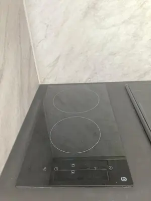 a stove top oven sitting in a counter top at Studio neuf parking piscine à Cannes in Cannes