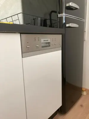 a kitchen with a stove and a white dishwasher at Studio neuf parking piscine à Cannes in Cannes