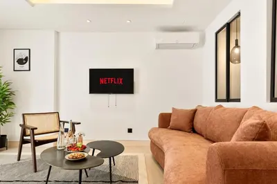 a living room with a couch and a table at Suite L Ecrin Élégance confort au cœur de Cannes in Cannes