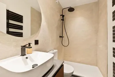 a bathroom with a sink and a toilet and a shower at Suite L Ecrin Élégance confort au cœur de Cannes in Cannes