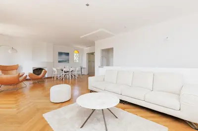a living room with a white couch and a table at Immogroom - Luxury Villa with Swimming Pool in City Center in Cannes